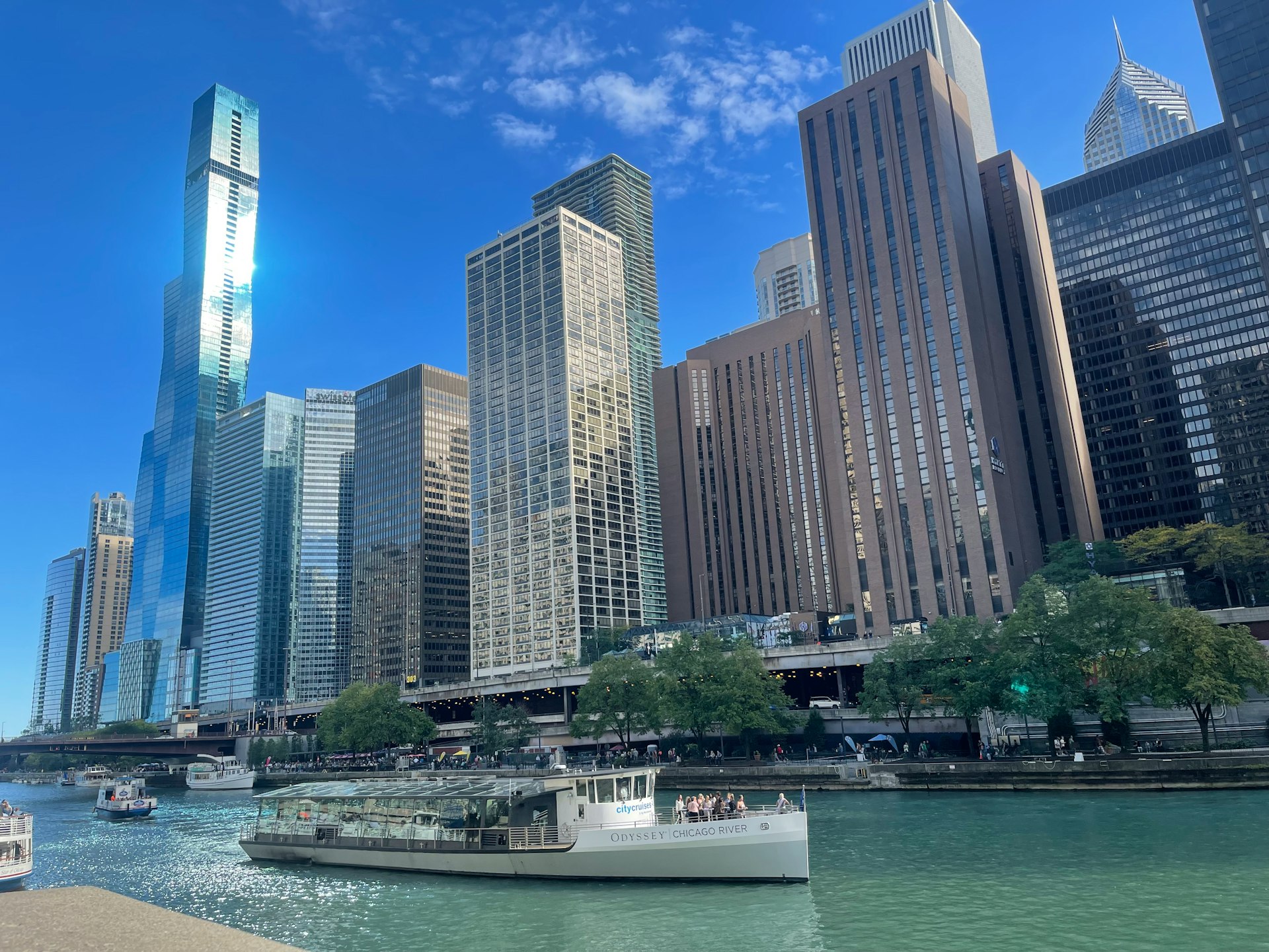 a boat traveling down a river next to tall buildings